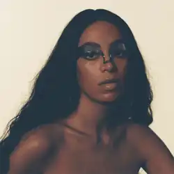 A photo of Knowles' face with a mask across her eyes
