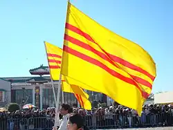 Vietnamese emigrés parading with Vietnamese Heritage and Freedom Flag during Tết festivities in Little Saigon, Orange County.