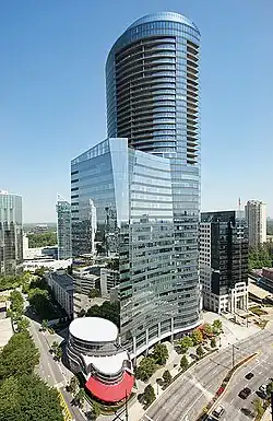 A glass-covered skyscraper in an urban setting