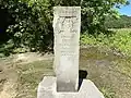 Monument to the Stone Head at the Stone Head Road marker