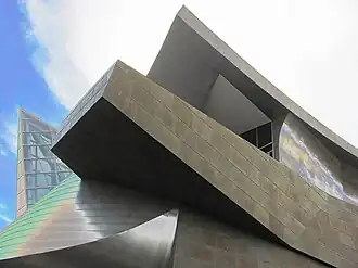 An exterior photo of the underside of a museum building balcony