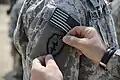 U.S. Army Sgt. Ashanti Harris, assigned to 1st Battalion, 21st Infantry Regiment, 2nd Advise and Assist Brigade, 25th Infantry Division, receives a combat patch from U.S. Army Lt. Philip Riglick, assigned to 1st Battalion, 21st Infantry Regiment, 2nd Advise and Assist Brigade, 25th Infantry Division, at Forward Operating Base Warhorse, Diyala province, Iraq, Aug. 21, 2010.