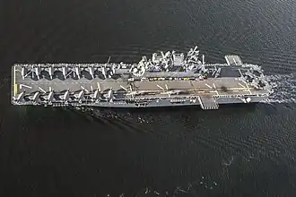 USS&nbsp;Tripoli&nbsp;(LHA-7), an America-class amphibious assault ship in light aircraft carrier mode with two squadrons of F-35B fighters aboard
