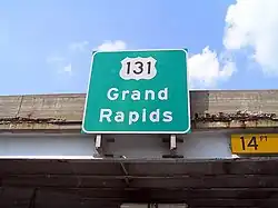 Guide sign mounted to a freeway overpass
