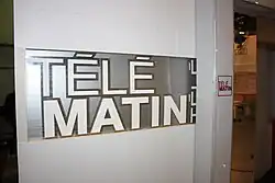 Photograph of the sign next to a door entrance