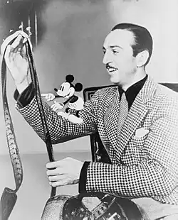 Image 3Disney with film roll and Mickey Mouse on his right arm in 1935 (from Walt Disney)