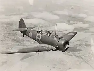 Single-engined two-seat military monoplane in flight, three-quarters overhead