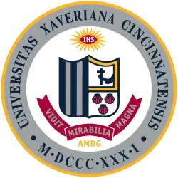 The Xavier University seal, like the St. Xavier seal, bears the schools' coat of arms, which consists of five vertical stripes, an arm holding a crucifix, and three seashells.