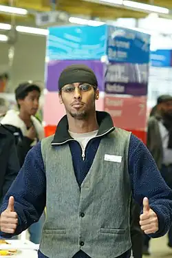 Somali man wearing waistcoat, tuque and polar fleece, illustrating East African diaspora fashion in 2010.