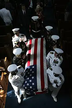 A casket team carries Major Douglas A. Zembiec, former commander of E Company, 2nd Battalion, 1st Marine Regiment from the Naval Academy Chapel in Annapolis, Maryland following a funeral service held in his honor.
