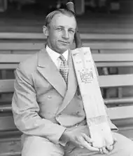 A cricketer holding a bat.